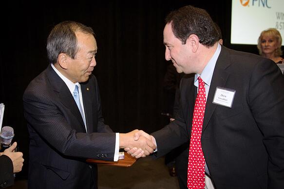 Marlin Steel President Drew Greenblatt greets Takeshi Uchiyamada, chairman of the board of Toyota Motor Corp.