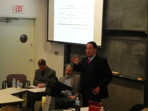 Left of Drew are Mike Mandina, president of Optimax, and MIT doctoral candidate Andrew Weaver