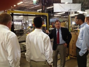 Describing the robots in safety cages to visitors at Marlin Steel