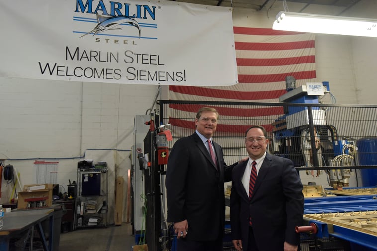 Drew Greenblatt and Eric Spiegel in front of Marlin Steel sign at the end of the State of Manufacturing Tour. 