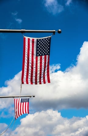 Two American Flags Flying from Flag Poles