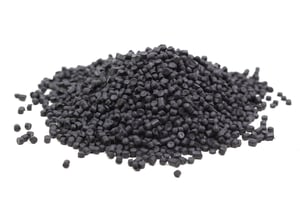 Black plastic polymer resin chips before being melted down into a coating for a wire basket.