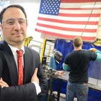 Drew Greenblatt posing in front of a Marlin Steel worker at the Baltimore factory.