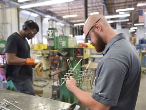 Production team and engineers on the factory floor.